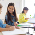 students recording their reading goals in a green fields school classroom