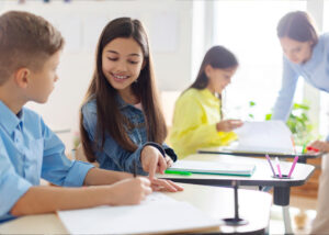 students recording their reading goals in a green fields school classroom